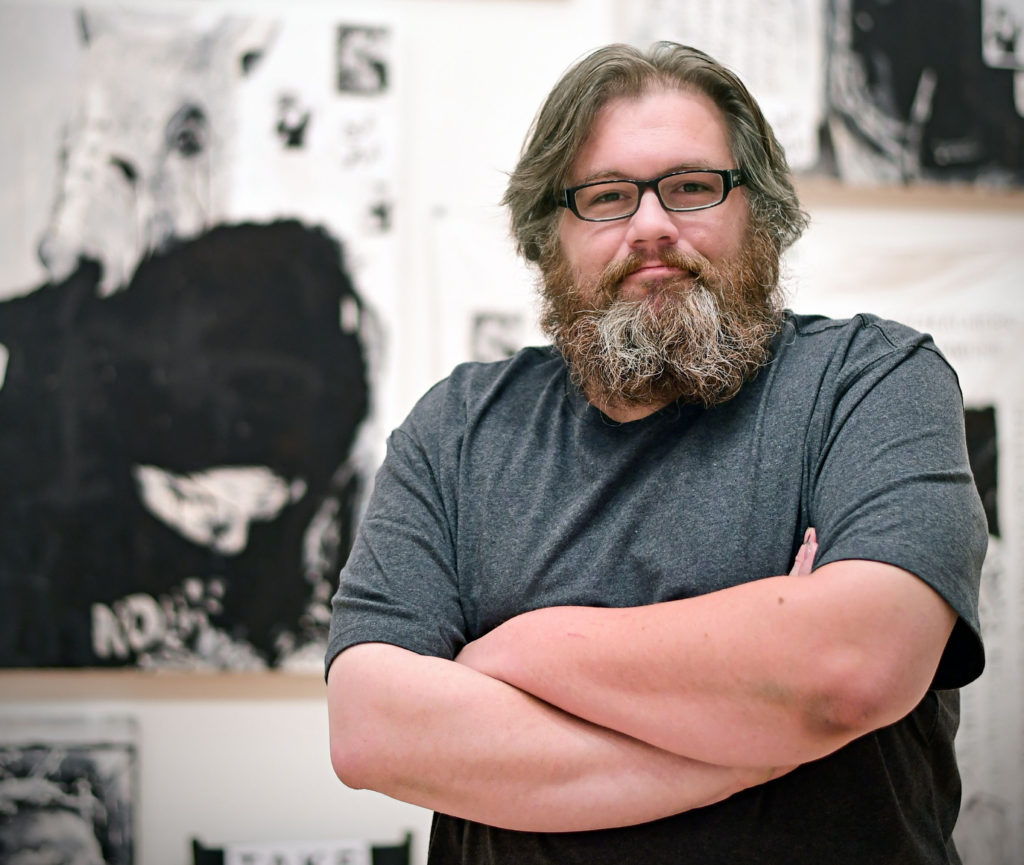 Adam Turl with his installation "Red Mars" at the Mildred Lane Kemper Art Museum. (James Byard/WUSTL Photos)