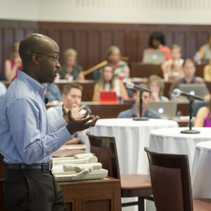 man speaks to conference