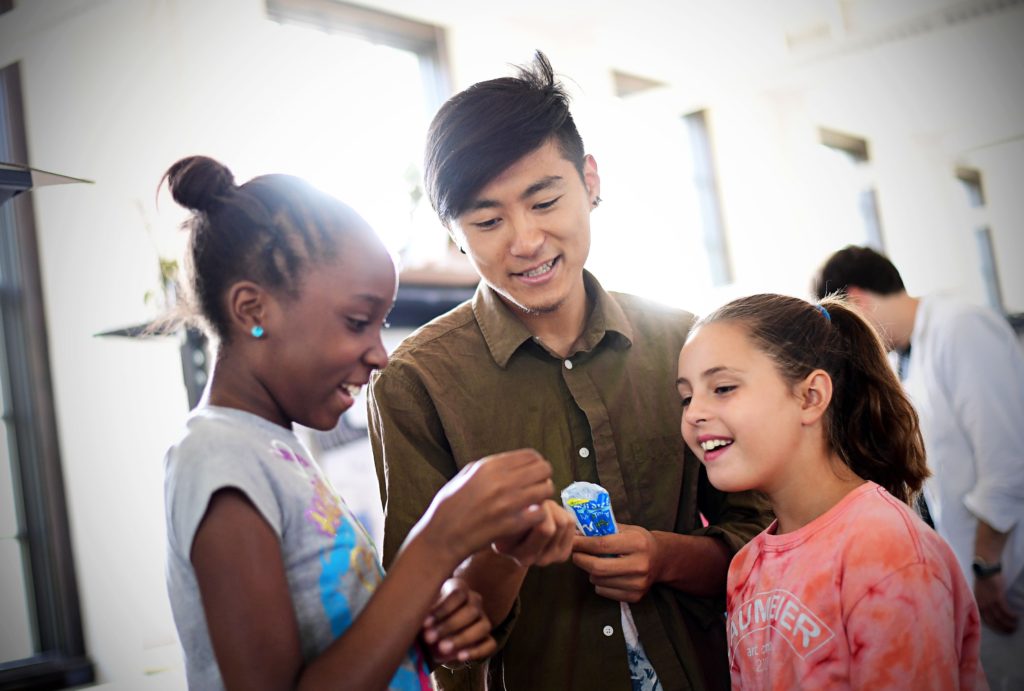 Recent graduate Jun Bae (center) works with students in the Sam Fox School's Alberti Program last June. (Photo: James Byard/Washington University)