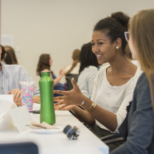 students talk at a table