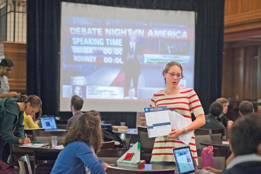 Presidential debate watch in the DUC, Oct. 3, 2012. Junior poly/sci major Sophie Schuit asks those attending if the are registered to vote. Photos by Mary Butkus