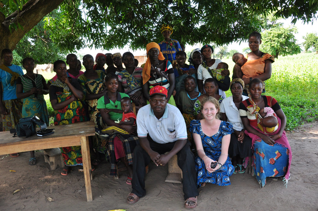 women in Tanzania pose for a photo with Adrienne Strong