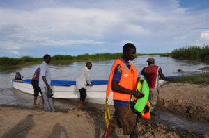 people ready a boat for a trip