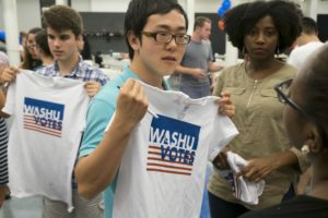 Undergraduate and graduate students from Washington University in St. Louis gathered Tuesday, Aug. 30, 2016 for the kickoff event for WashU Votes, an effort to encourage student involvement in the 2016 election and the 2016 Presidential Debate being hosted on the WU Campus Oct. 9, 2016. The WashU Votes program is part of the Gephardt Institute for Civic and Community Engagement. Student Nero Zhou (center) checks a t-shirt for size. Photo by Sid Hastings / WUSTL Photos