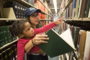 SATURDAY, SEPT. 24, 2016 - Washington University student Julia Zigman, with the Kappa Delta sorority, gives a tour of the library to Sophia Hill, 3, during Greek Day of Service, now an annual tradition, that hosts dozens of KIPP families on the Washington University campus. Young KIPPsters and their parents toured campus and participated in activities. The program gives young students a look at college life. Photo by Jerry Naunheim Jr./WUSTL Photos