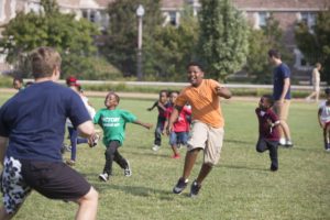 SATURDAY, SEPT. 24, 2016 - Washington University student Ilan Wallentin (left), a member of the Alpha Epsilon Pi fraternity, horses around with Camden Butler, 5, during Greek Day of Service, now an annual tradition, that hosts dozens of KIPP families on the Washington University campus. Young KIPPsters and their parents toured campus and participated in activities. The program gives young students a look at college life. Photo by Jerry Naunheim Jr./WUSTL Photoss