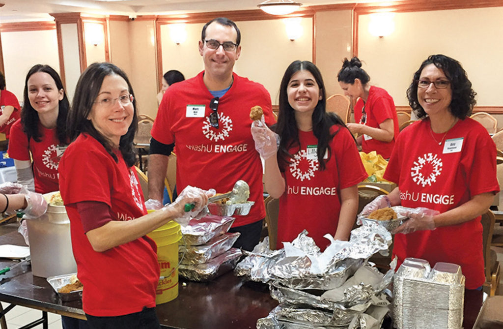 The United Jewish Council of the East Side works to preserve and stabilize the Lower East Side of ­Manhattan community through a range of human services and ­community development programs that primarily address the needs of the elderly. On April 17, 40 WashU volunteers served lunch to 93 participants, distributed a “picnic in a bag” dinner and played bingo with the seniors. (Courtesy photo)