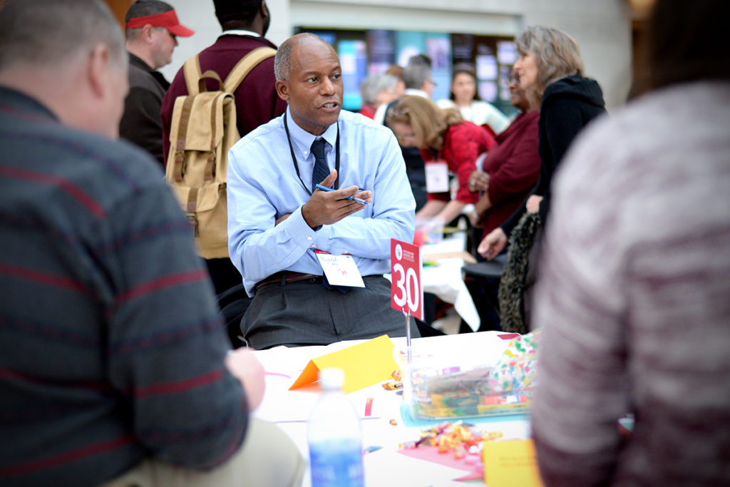 man speaks at table