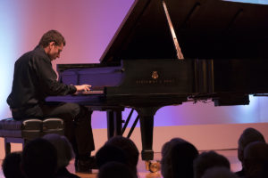 man plays piano