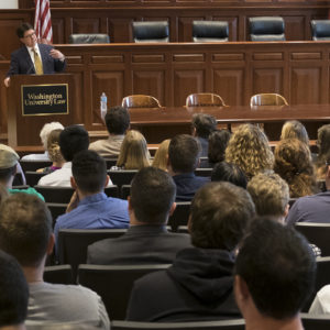 man speaks to students