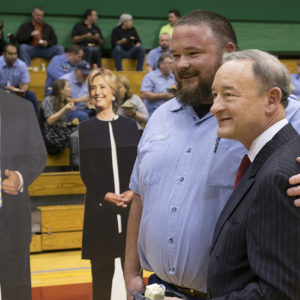 employees enjoy debate thank you lunch, with cutouts of candidates nearby