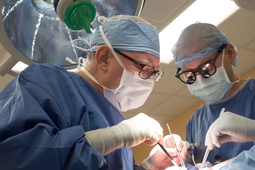 Robert W. Thompson, MD, (left) professor of surgery at Washington University School of Medicine in St. Louis, operates on a patient suffering from thoracic outlet syndrome, a nerve-compression injury. He is assisted by William Chapman Jr., MD, a surgical resident. (Photo: Robert Boston/School of Medicine)