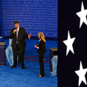 people on stage stand in for candidates