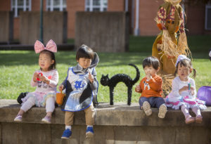 children in costumes enjoy candy