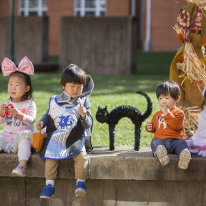 children in costumes enjoy candy