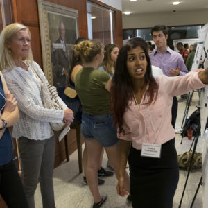 students present posters of their work