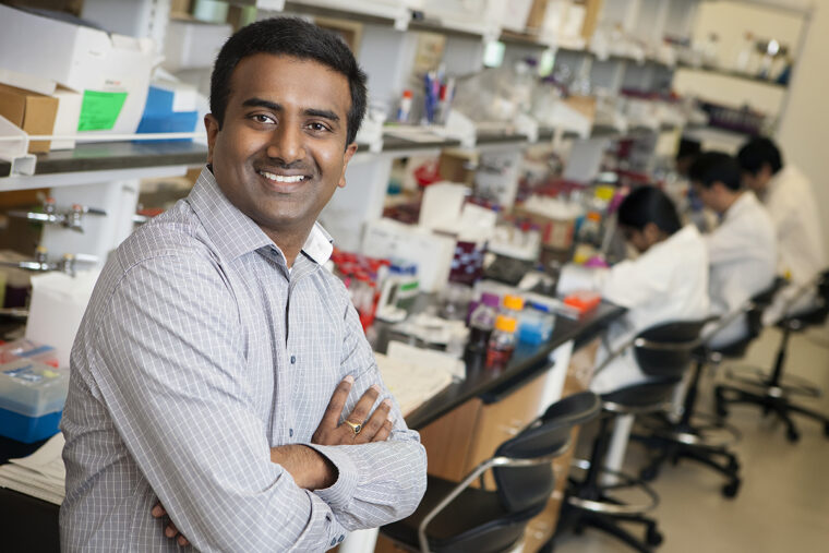 Headshot of professor Srikanth Singamaneni, standing in a lab