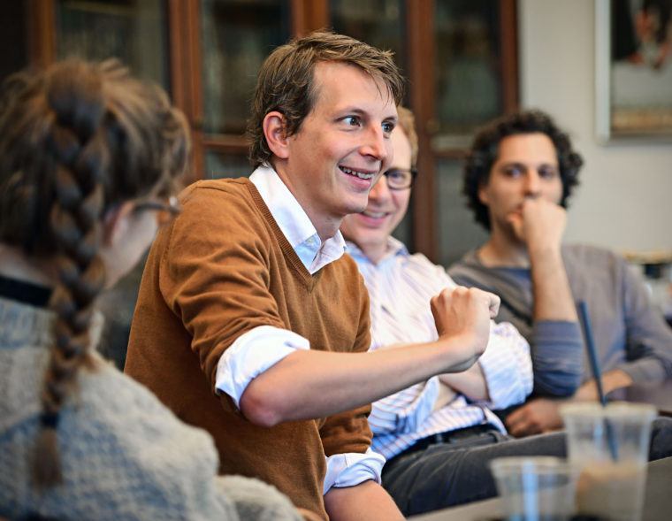 Alumnus Garth Risk Hallberg (center), author of the bestselling novel “City on Fire,” came to WashU to deliver an Assembly Series talk in September 2016. Prior to his address, he met with students in the humanities to discuss the writing life. (Photo: James Byard/Washington University)