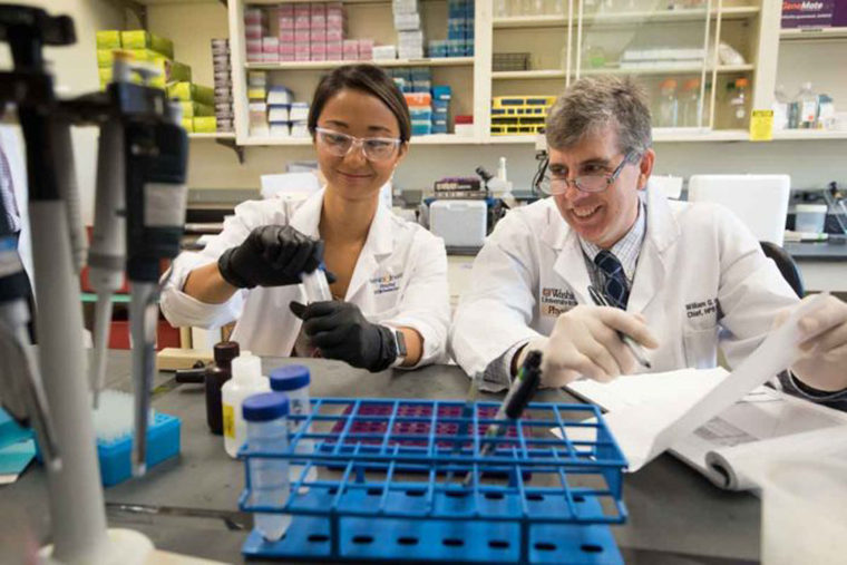 William Hawkins and researcher in lab