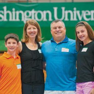 Robert Kilo, BSBA ’92, his wife, Kathy, and their children, Nicholas and Caroline, enjoy Fall Festival activities. (Sid Hastings/Washington University)