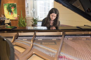 student plays piano