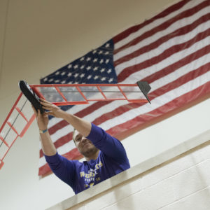 a student launches a glider during the Boeing Engineering Challenge