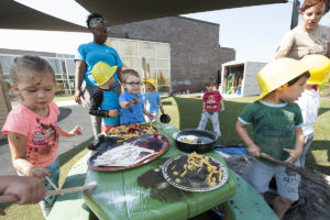 kids play at a table full of mud