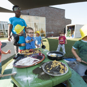 kids play at a table full of mud