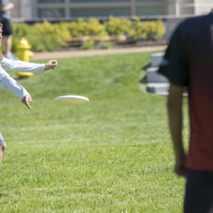 students toss a Frisbee