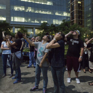 employees watch solar eclipse