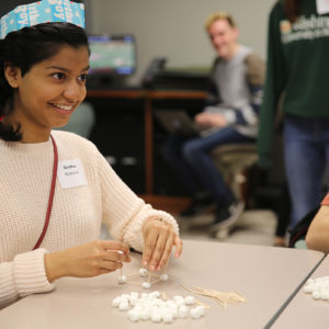 student builds with marshmallows and toothpicks