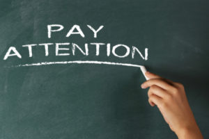 Pay Attention written on chalkboard