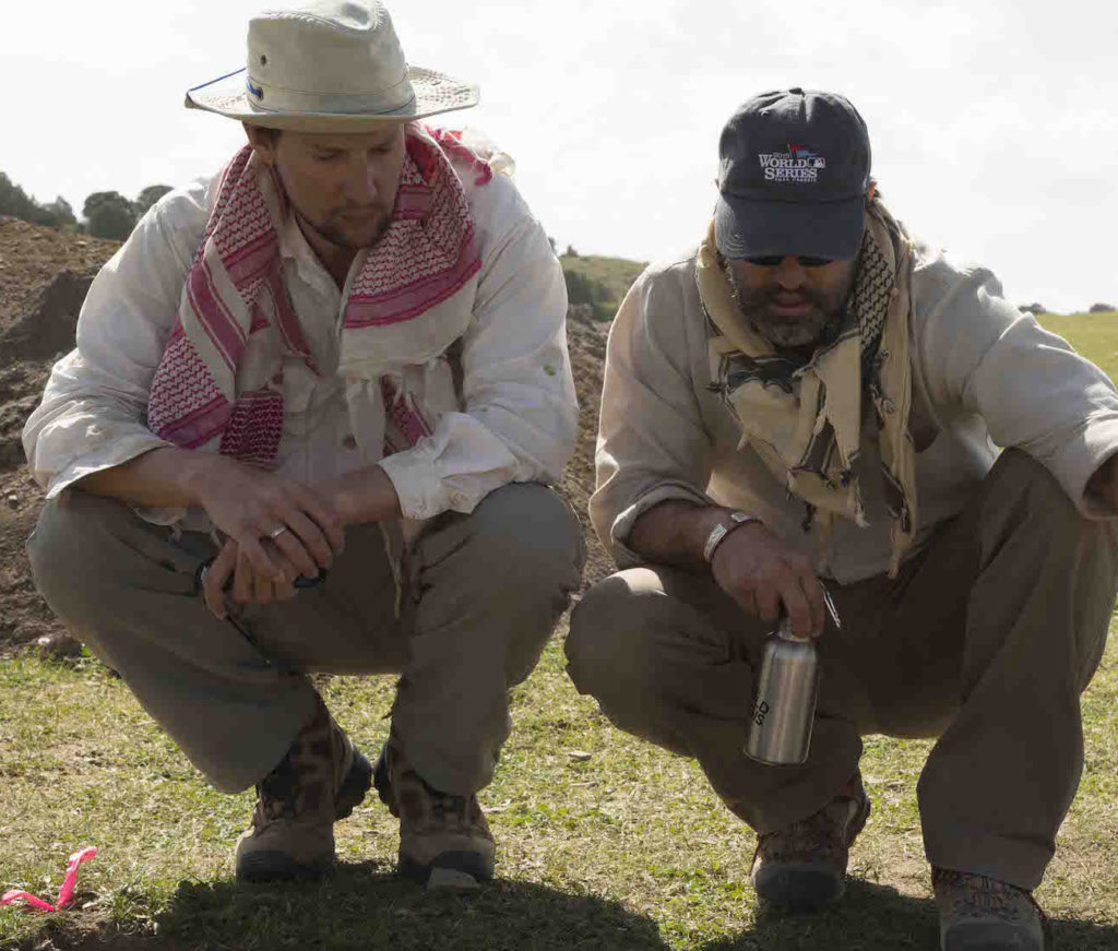 Archaeologists Taylor Hermes (left) and Michael Frachetti scope out a dig site at an ancient nomadic site high in the mountains of Uzbekistan.