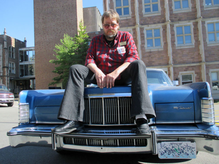 Gerry Rohde on hood of a car