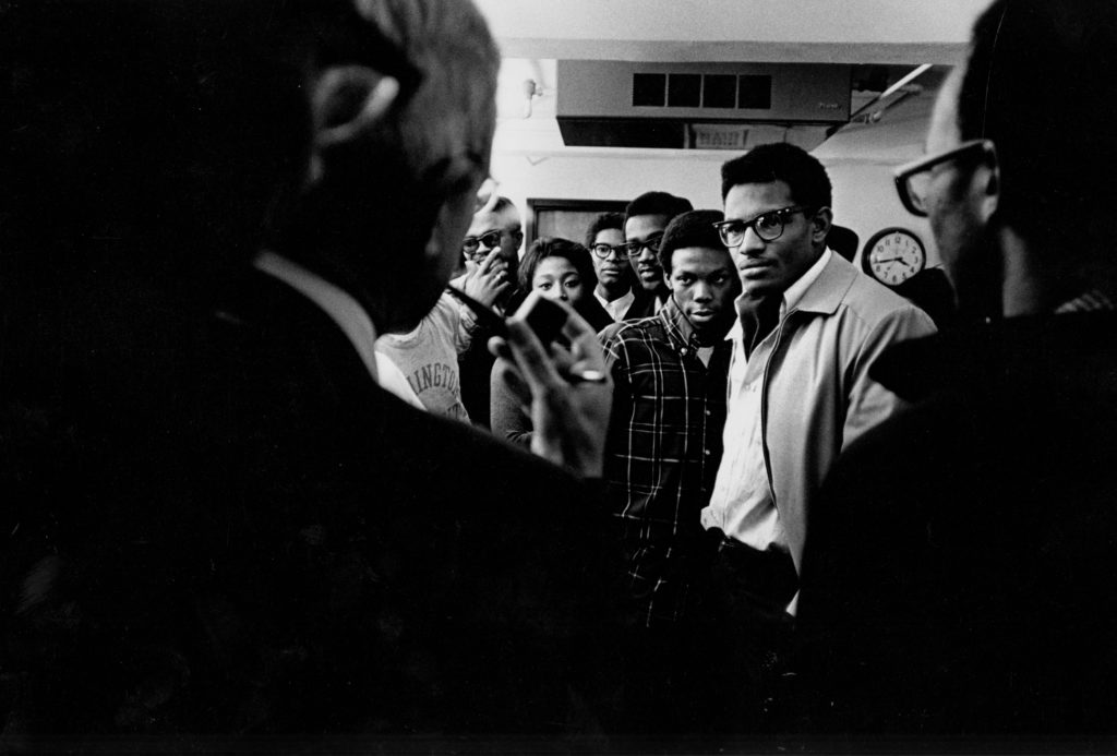 Eliot with his ever-present pipe speaks with students