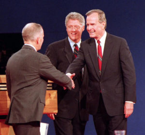 President Bush greets Ross Perot at the 1992 presidential debate held on campus, while candidate Bill Clinton looks on.