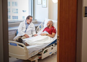 John F. DiPersio speaks with a patient