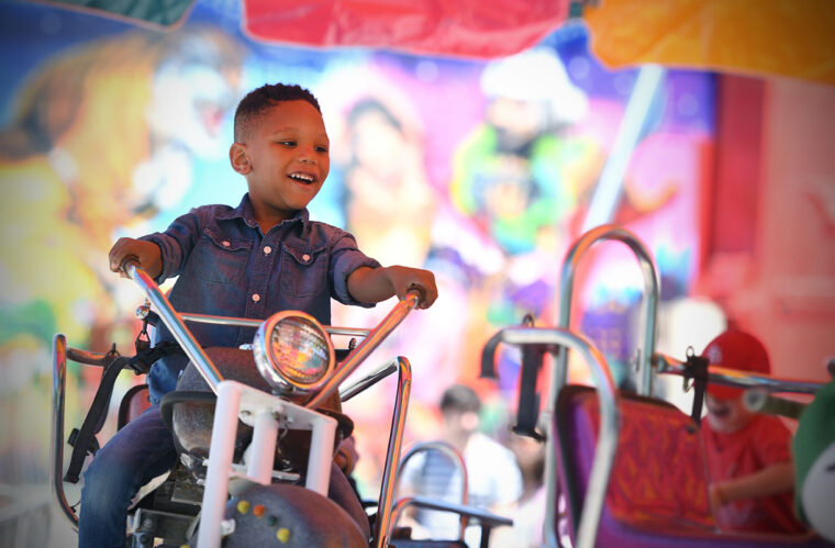 child on a carnival ride