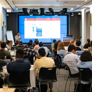 A room of students listen to a presentation.