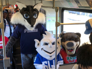 Mascots riding the train