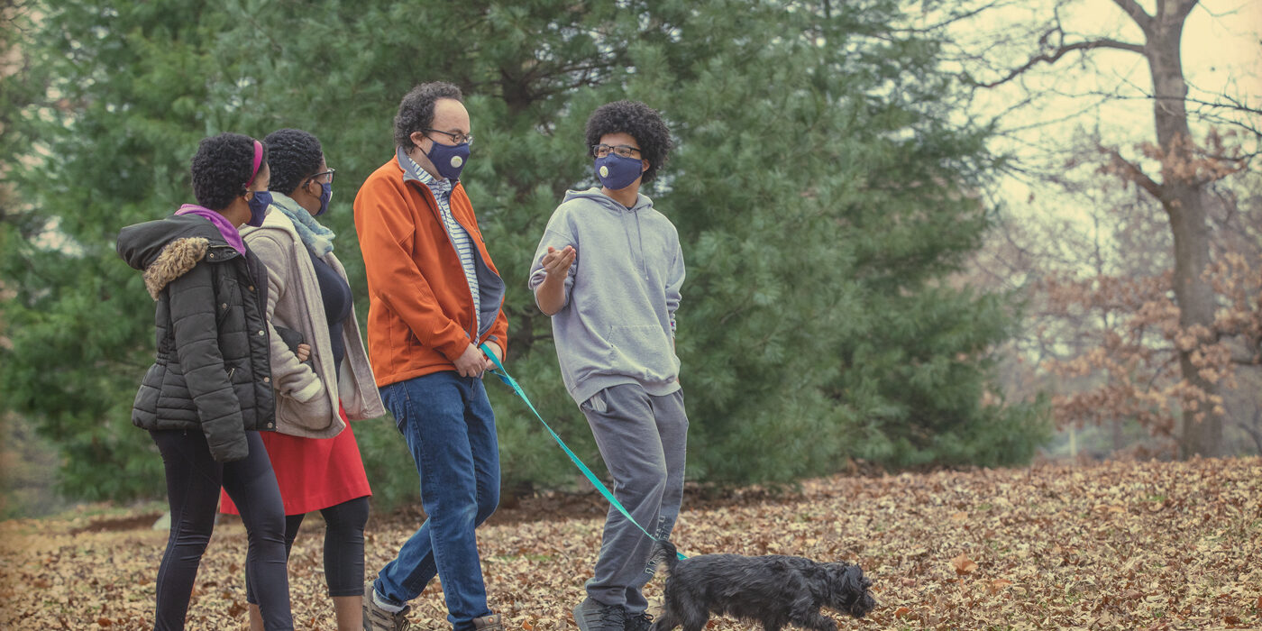 The Nussinov family — (from left) Maya, Tsitsi, Zohar and Ethan — walking their dog, Pi, in Clayton’s Oak Knoll Park. (Photo: Joe Angeles/Washington University)