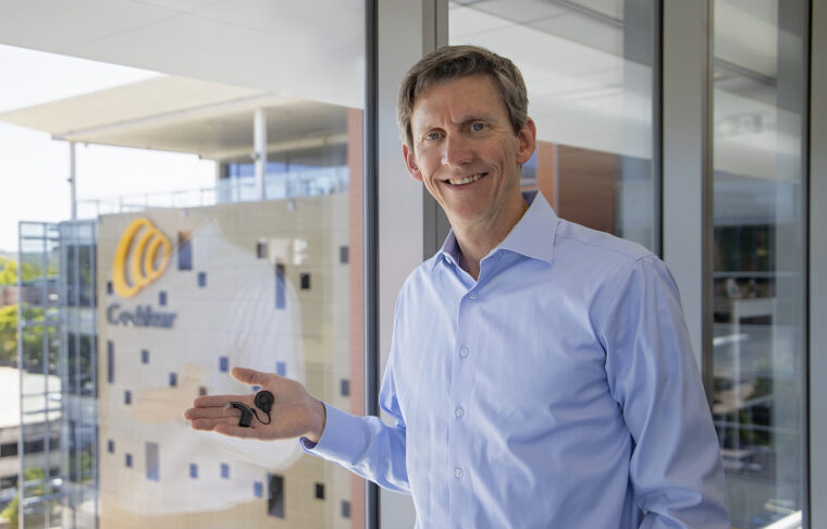 Roger Smith at Cochlear in Australia holding a Cochlear implant