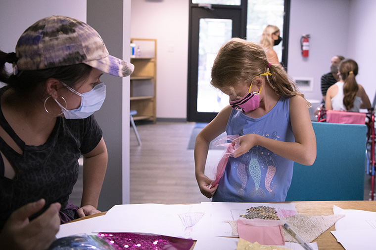 Future model Anna Bloom (right) envisions the look of a future dress with designer Maxine Roeder at a design consult on Sept. 30 (Photo: Carol Green/Washington University)