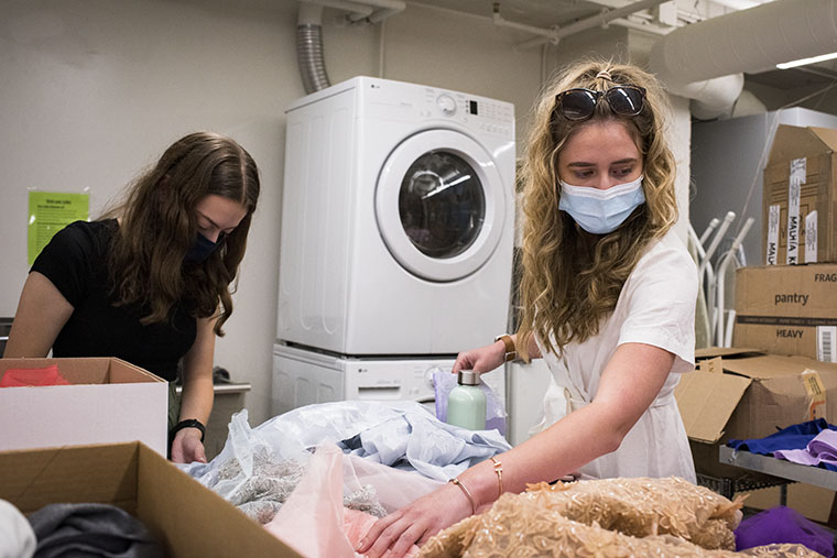 Olivia Baba (right) sorts through fabric remnants donated to the "Made to Model" program designers by Paula Varsalona. (Photo: Carol Green/Washington University)