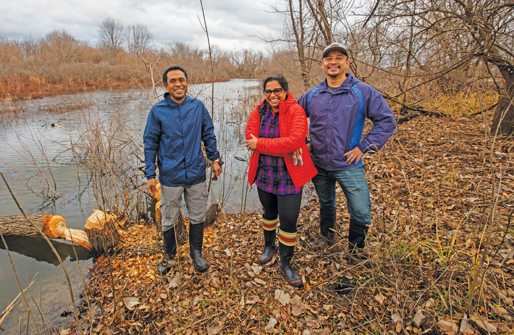 Arpita Bose (center) works with Tahina Ranaivoarisoa (left), Bose’s research lab supervisor, and Rajesh Singh collecting microbes at Ellis Island. (Photo: Joe Angeles/Washington University)