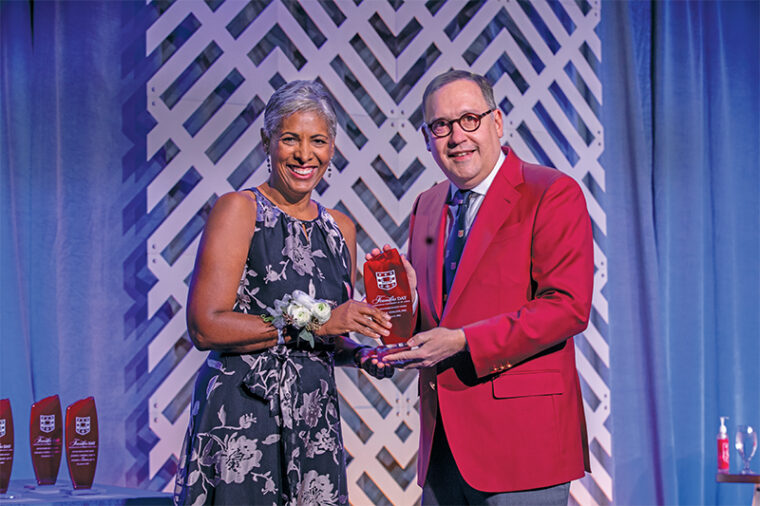 Chancellor Andrew D. Martin presents Sarah K. England, MD, the Alan A. and Edith L. Wolff Pro-fessor of Medicine, with a Distinguished Faculty Award at the university’s 2021 Founders Day celebration. England, professor of obstetrics and gynecology in the School of Medicine, was among four faculty members recognized for their outstanding commitment to the intellectual and personal development of students. Photo: Joe Angeles