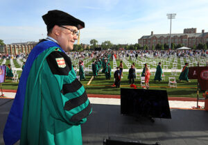 Chancellor Andrew D. Martin on the Commencement stage on Francis Olympic Field.