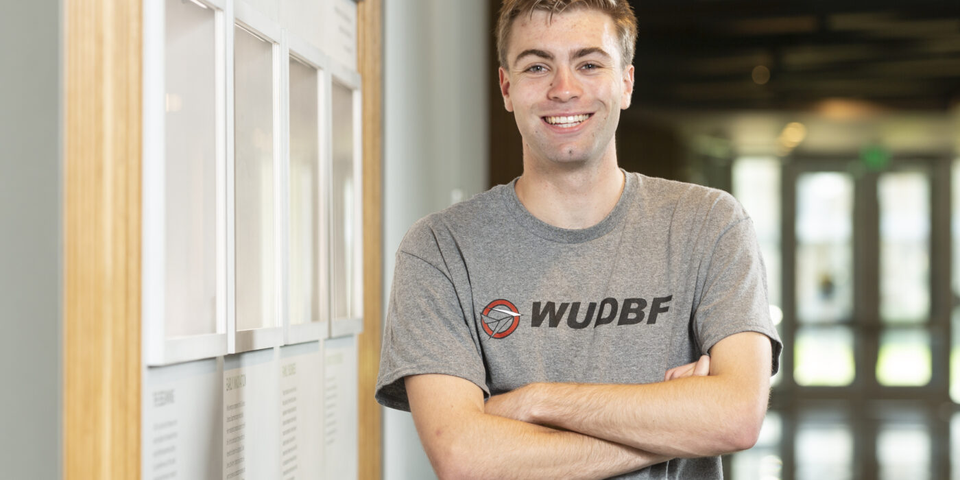 Miles Petersen poses in his Design Build Fly shirt