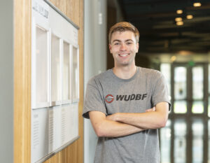 Miles Petersen poses in his Design Build Fly shirt