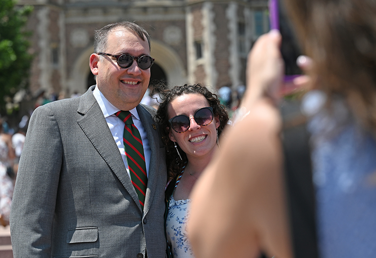 Graduate poses with Chancellor Andrew Martin